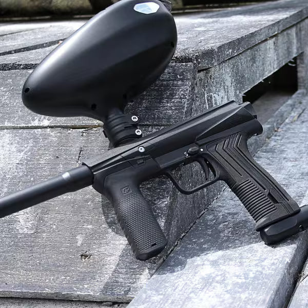 Planet Eclipse EMEK 100 Mechanical Paintball Marker – Black laid down on a gray bench
