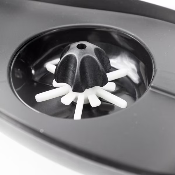 Close-up view of the Valken V-MAX Plus loader's internal paddle wheel feed system, a fan-shaped rotating mechanism that ensures smooth, high-speed paintball feeding without jams.

